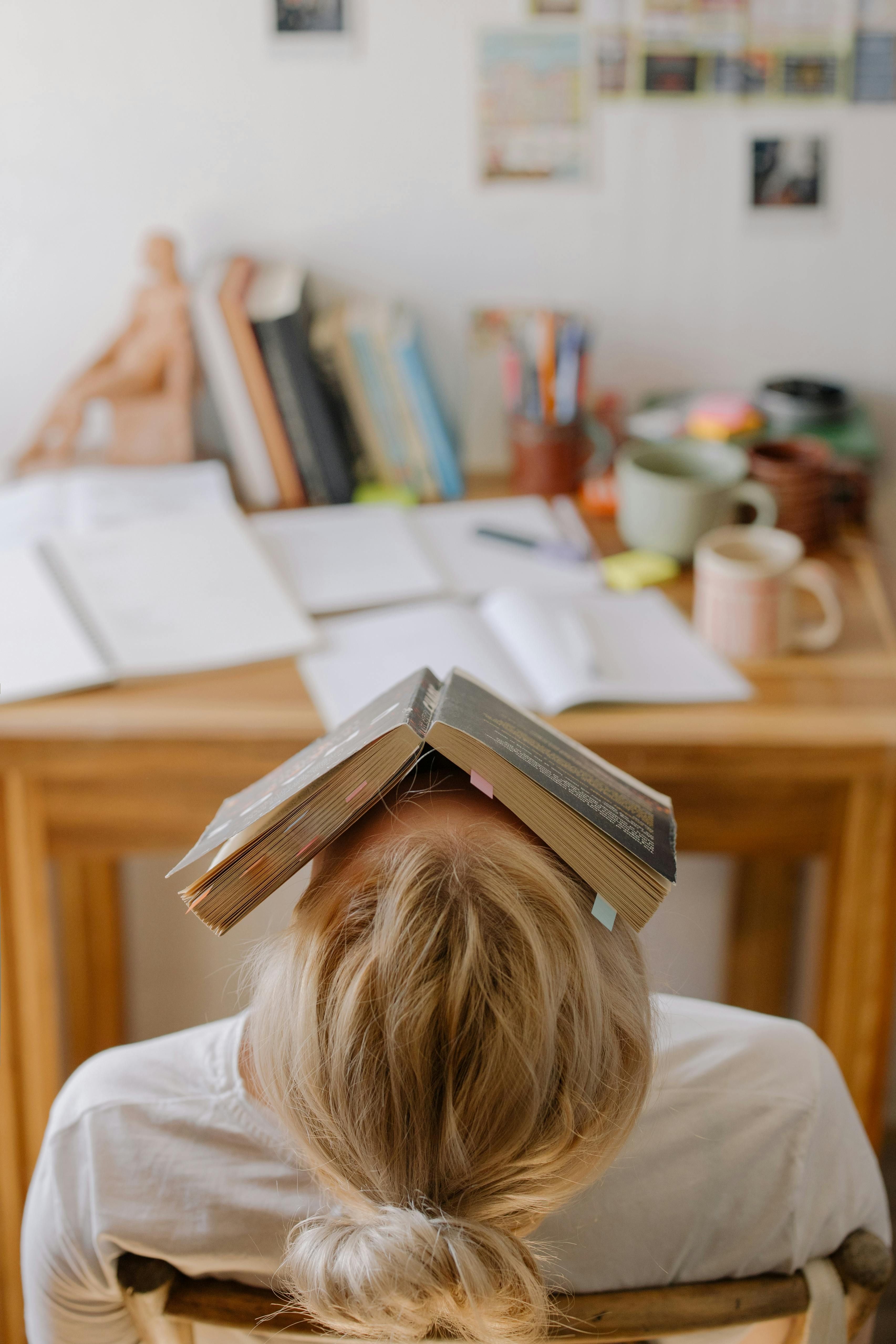 Teacher looking stressed while managing paperwork and a noisy classroom